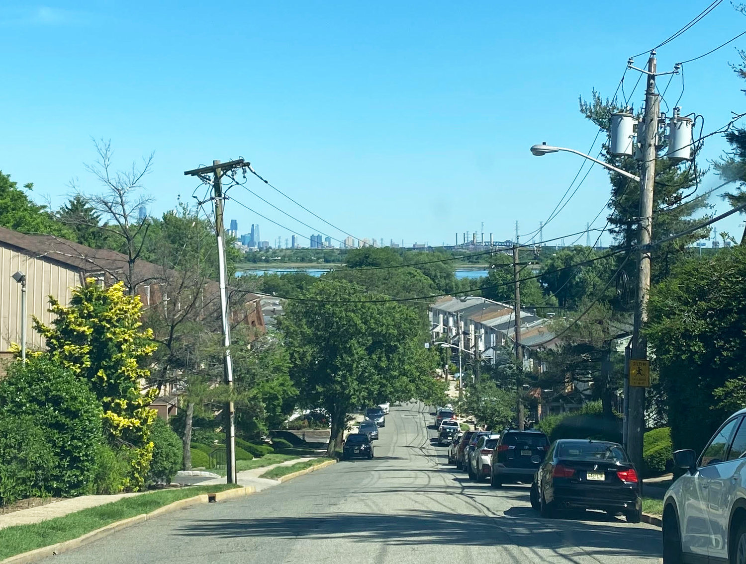 The rowhouse development built in the 1970s plunges down the hill off Schuyler Avenue in Kearny, N.J., ending in a cul de sac at the edge of the Meadowlands, with the New York City skyline in the distance.